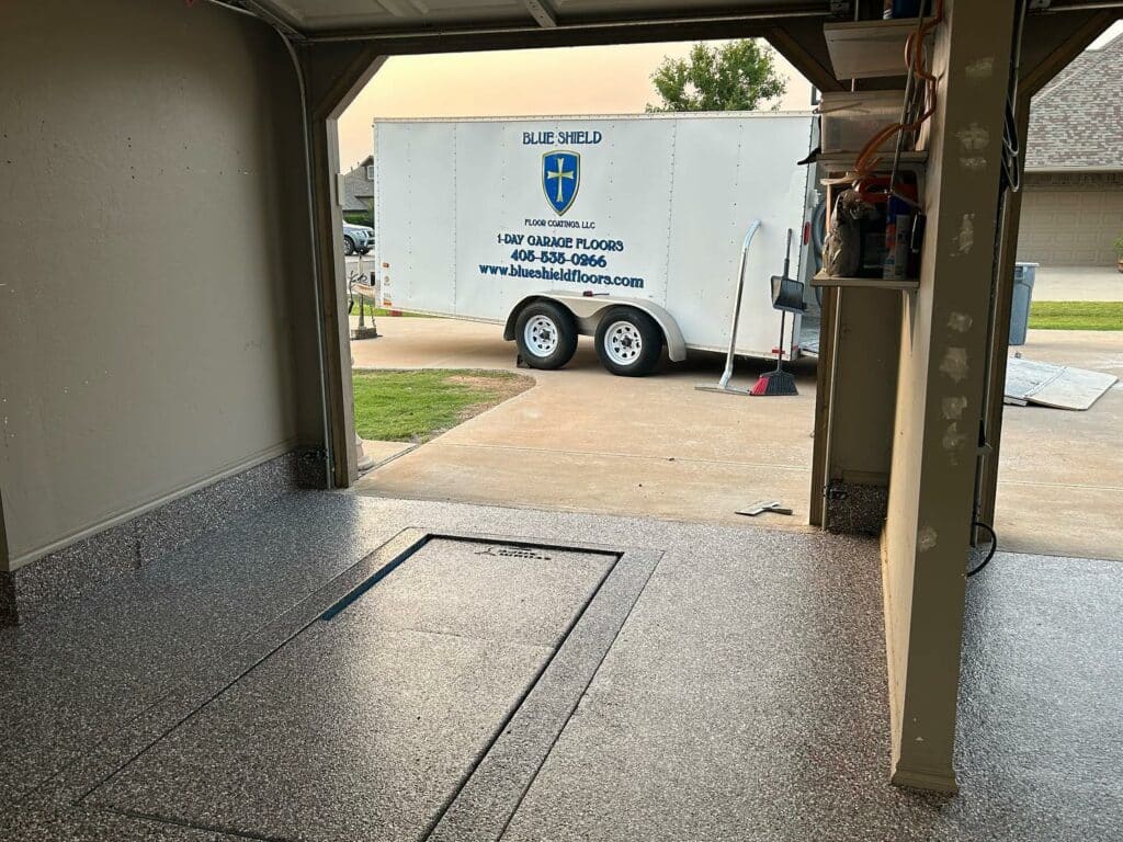 garage with storm shelter and blue shield trailer