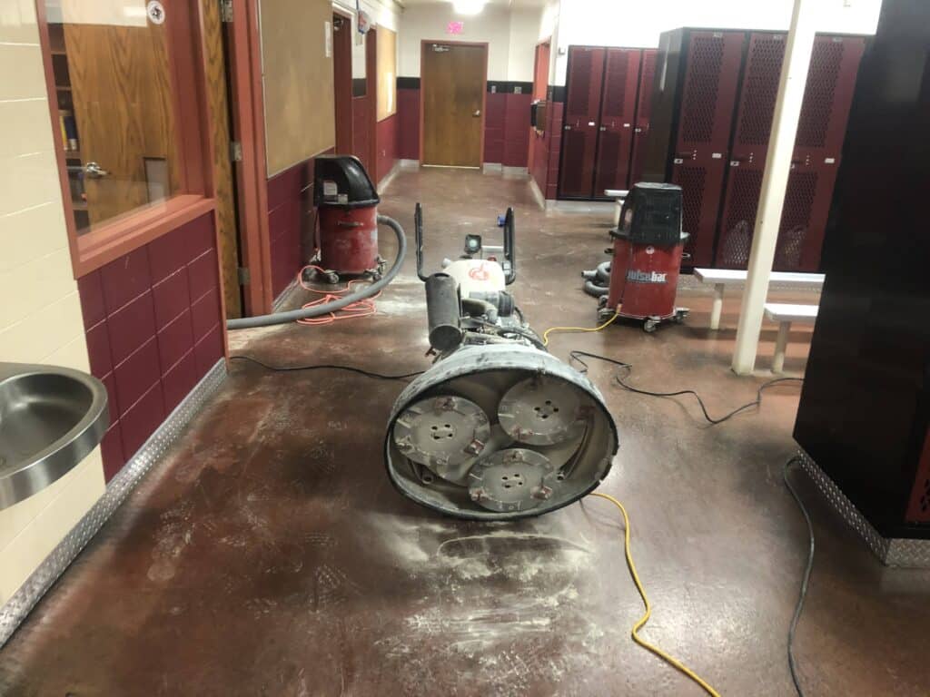 locker room floor being prepped for concrete floor coating