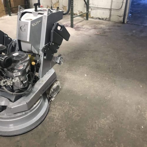 Grinder concrete floor with grinder equipment being prepped to use