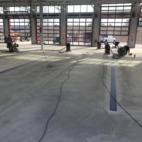 firestation floor being prepped for concrete coating application